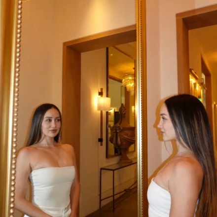beautiful woman looking in mirror